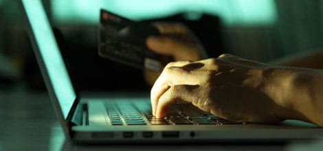 Man at keyboard with credit card